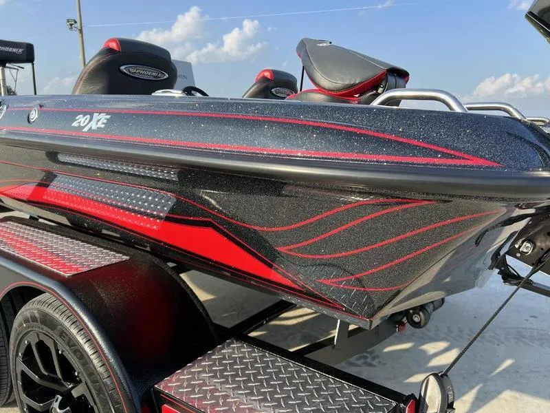 Slide: The Image of 2024 Phoenix 20 XE boat with red and black design on trailer. - 3