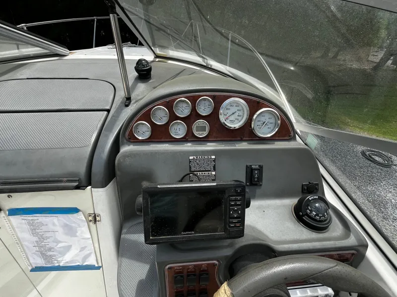 Slide: The Image of Dashboard of a 2005 Bayliner 245 boat with gauges and navigation equipment. - 10