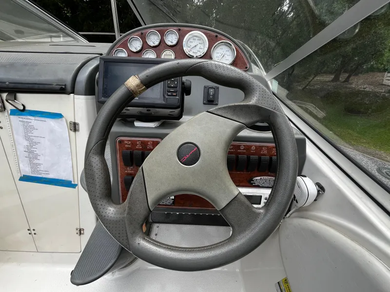 Slide: The Image of Steering wheel and dashboard of a 2005 Bayliner 245 boat. - 14