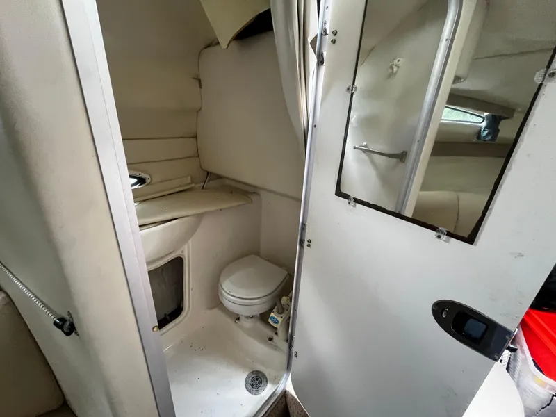 Slide: The Image of 2005 Bayliner 245 boat interior bathroom with toilet and sink. - 19
