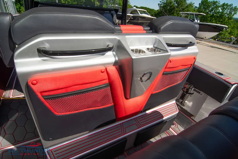 Slide: The Image of 2021 Fountain 38 SC boat interior with red and black seating and cup holders. - 29