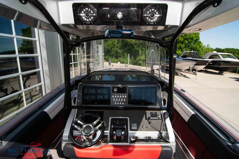 Slide: The Image of 2021 Fountain 38 SC boat dashboard with modern controls and navigation screens. - 32