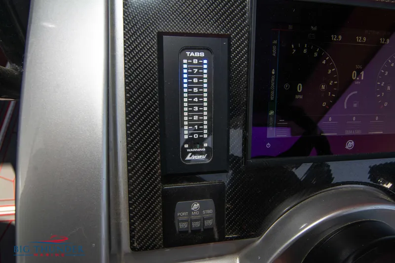 Slide: The Image of Control panel of a 2021 Fountain 38 SC boat with digital display and trim tabs. - 45
