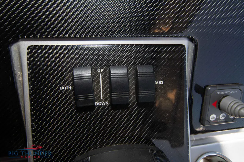 Slide: The Image of Control panel of a 2021 Fountain 38 SC boat with carbon fiber finish. - 48