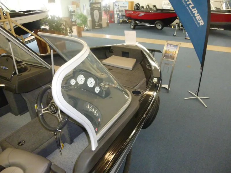 Slide: The Image of 2022 Crestliner 1750 Super Hawk WT JS boat interior with dashboard and seating. - 4
