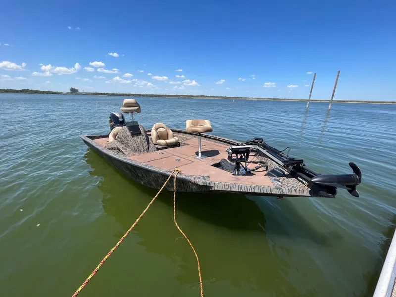 Slide: The Image of 2024 Xpress HyperLift H17 boat on calm water under clear blue sky. - 11