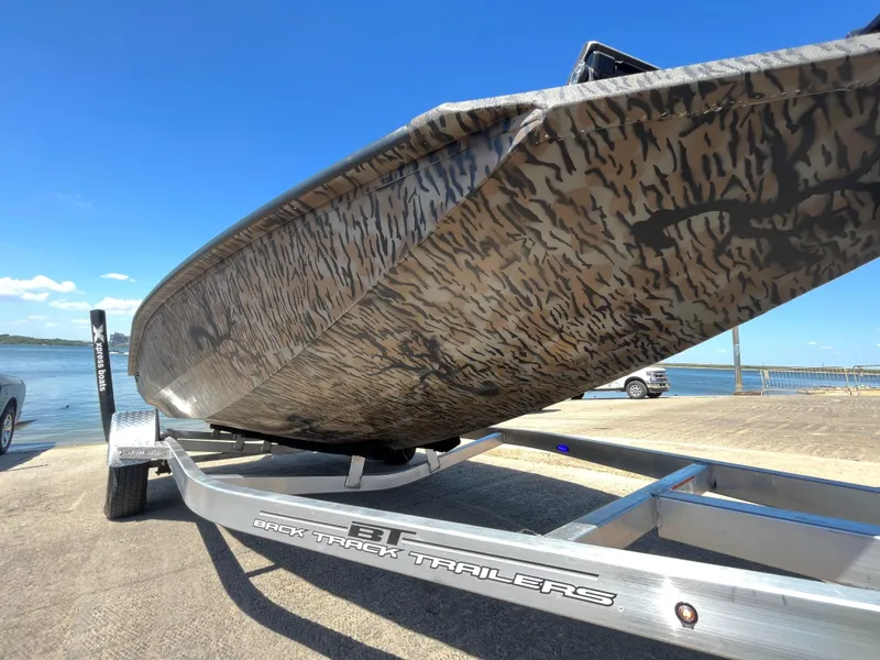 Slide: The Image of 2024 Xpress HyperLift H17 boat on trailer by the water. - 15