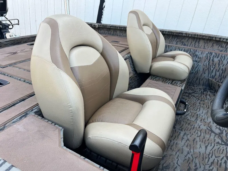 Slide: The Image of 2024 Express HyperLift H17 boat interior with beige and brown seats. - 22