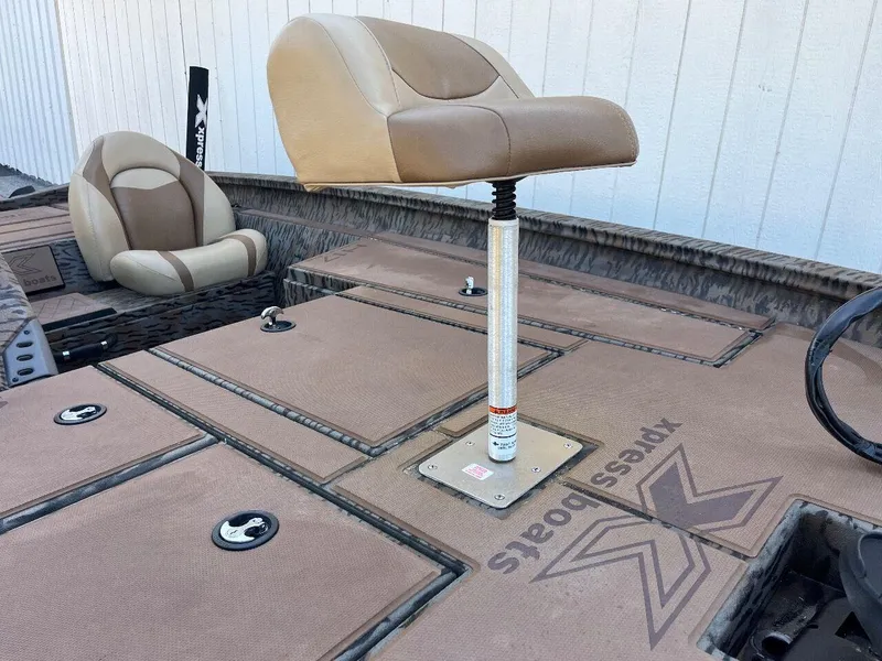 Slide: The Image of 2024 Express HyperLift H17 boat with elevated seating and storage compartments. - 25