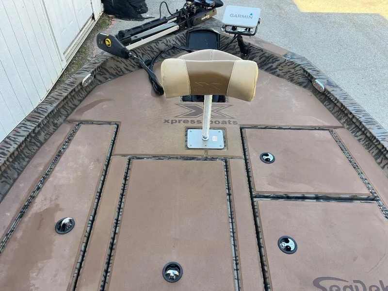 Slide: The Image of 2024 Express HyperLift H17 boat deck with Garmin equipment and storage compartments. - 26