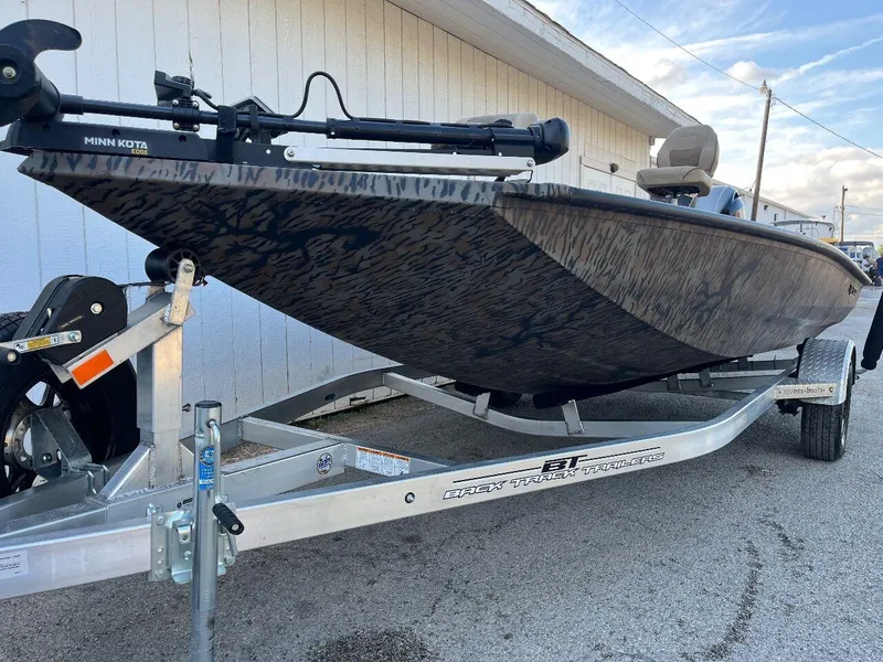 Slide: The Image of 2024 Express HyperLift H17 boat on trailer, side view, outdoors. - 32