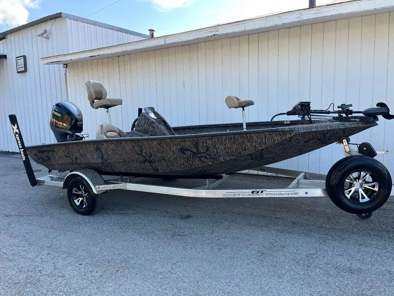 Slide: The Image of 2024 Express HyperLift H17 fishing boat on a trailer, parked beside a white building. - 35