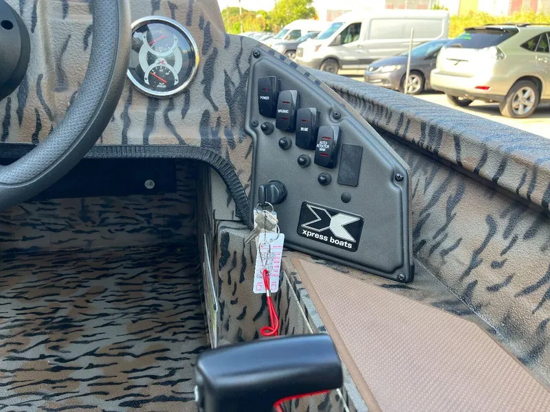 Slide: The Image of 2024 Express HyperLift H17 boat dashboard with tiger stripe pattern and control panel. - 44