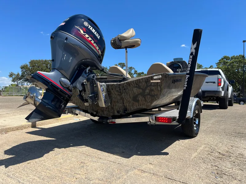 Slide: The Image of 2024 Xpress HyperLift H17 boat with Yamaha motor on trailer, parked outdoors. - 5