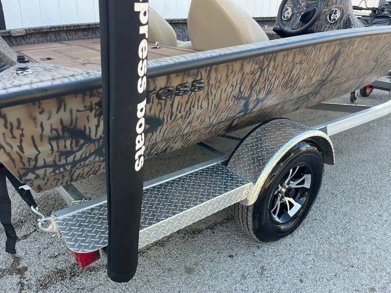 Slide: The Image of 2024 Express HyperLift H17 boat with camouflage design on a trailer. - 50