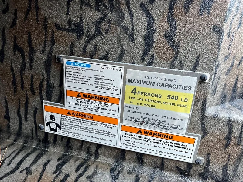 Slide: The Image of 2024 Express HyperLift H17 boat safety and capacity labels, U.S. Coast Guard maximum capacities. - 52