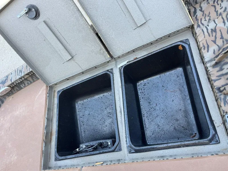 Slide: The Image of Open storage compartments on a 2024 Express HyperLift series H17 boat. - 55