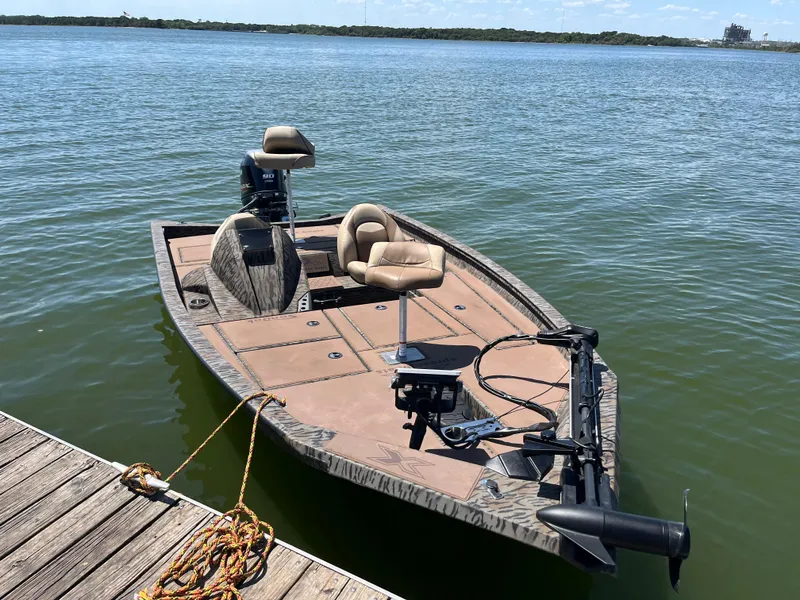 Slide: The Image of 2024 Xpress HyperLift H17 boat docked on calm water. - 9