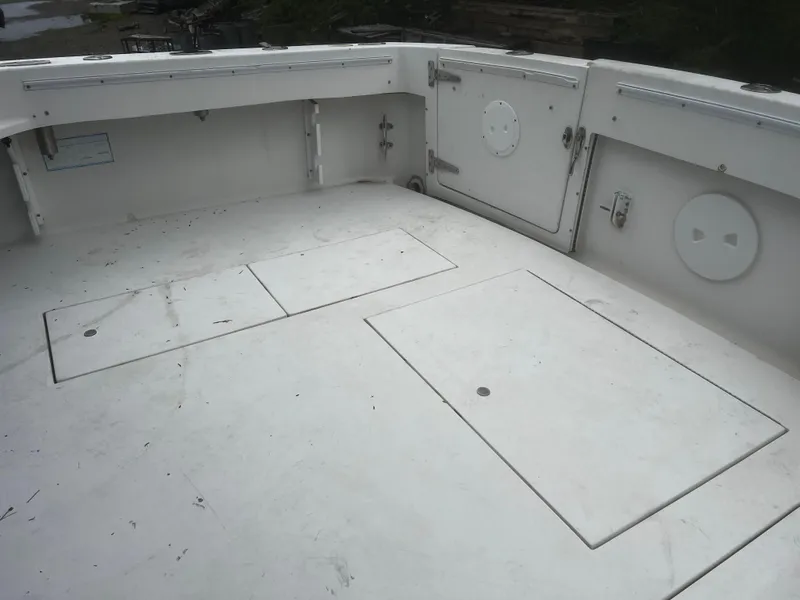 Slide: The Image of 2000 Wellcraft 330 Coastal boat deck with storage compartments and clean white surface. - 10