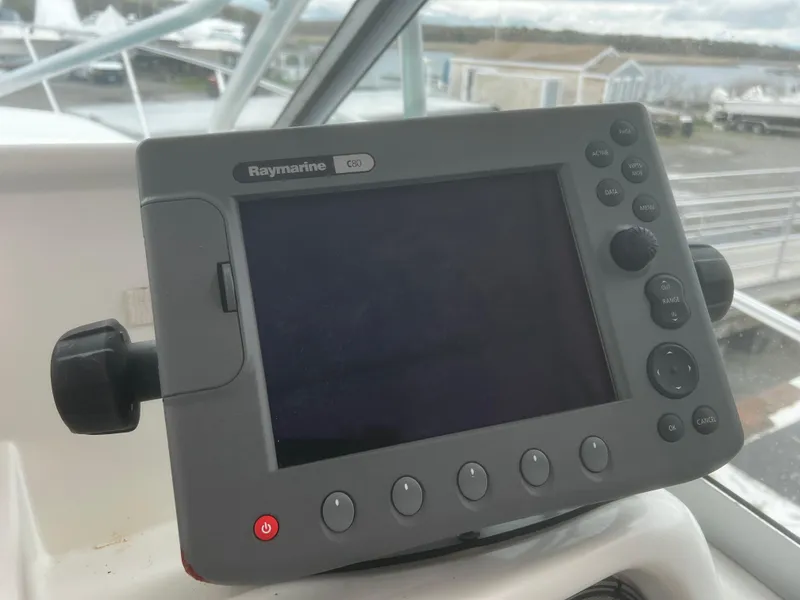 Slide: The Image of Raymarine GPS device on 2000 Wellcraft 330 Coastal boat dashboard. - 17