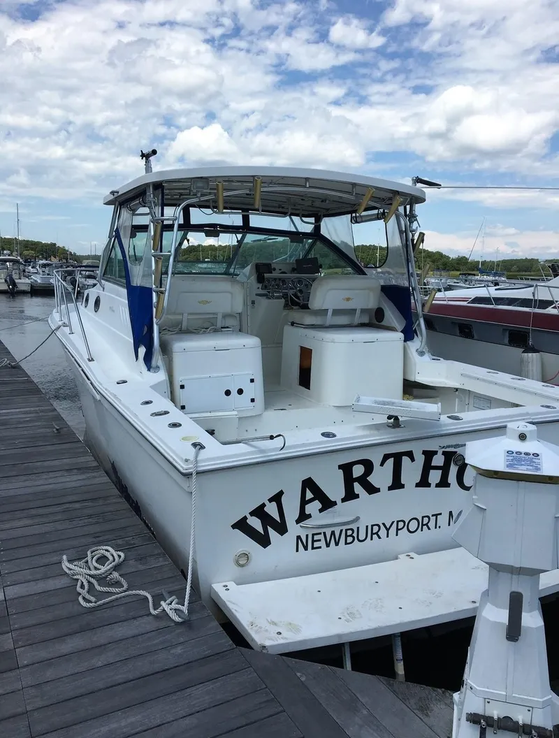 Slide: The Image of 2000 Wellcraft 330 Coastal boat docked in Newburyport, MA, under a partly cloudy sky. - 2