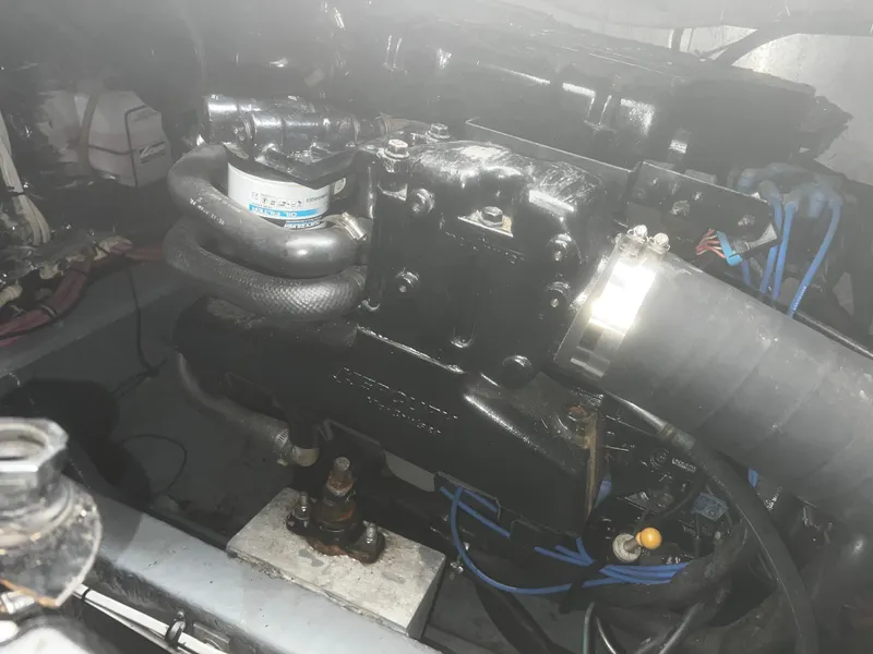 Slide: The Image of Engine compartment of a 2000 Wellcraft 330 Coastal boat, showcasing mechanical components. - 21