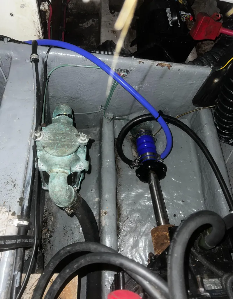 Slide: The Image of Engine compartment of a 2000 Wellcraft 330 Coastal boat, showing mechanical components and wiring. - 26
