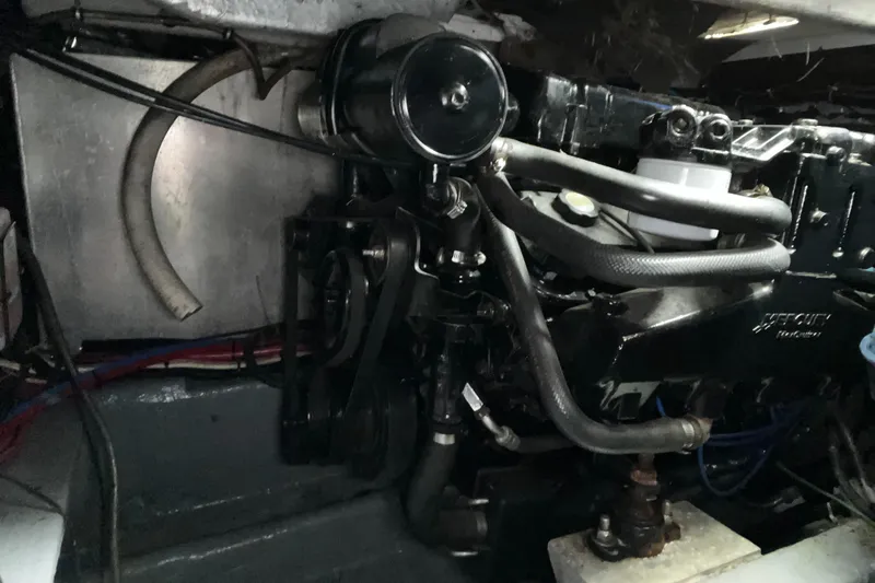 Slide: The Image of Engine compartment of a 2000 Wellcraft 330 Coastal boat, showcasing mechanical components. - 28