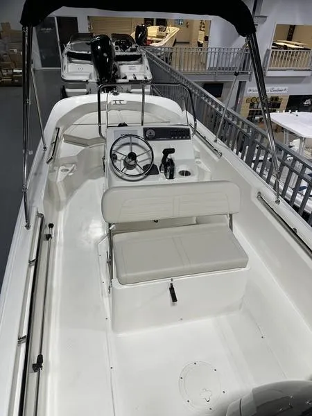 Slide: The Image of 2025 Boston Whaler 170 Montauk boat interior with steering console and seating. - 10