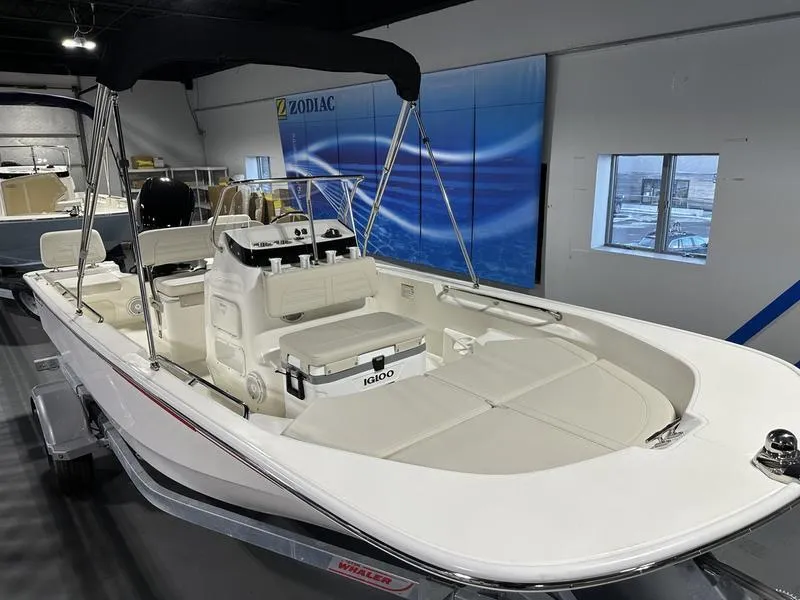Slide: The Image of 2025 Boston Whaler 170 Montauk boat in showroom, featuring sleek design and spacious interior. - 3