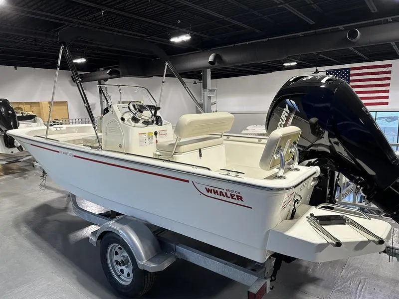 Slide: The Image of 2025 Boston Whaler 170 Montauk boat on trailer in showroom. - 4