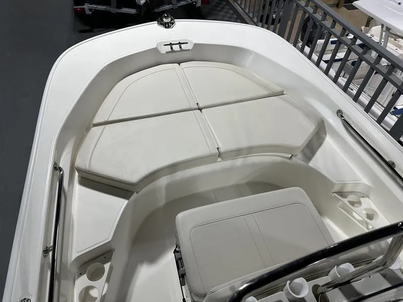 Slide: The Image of 2025 Boston Whaler 170 Montauk boat interior with cushioned seating and storage. - 7
