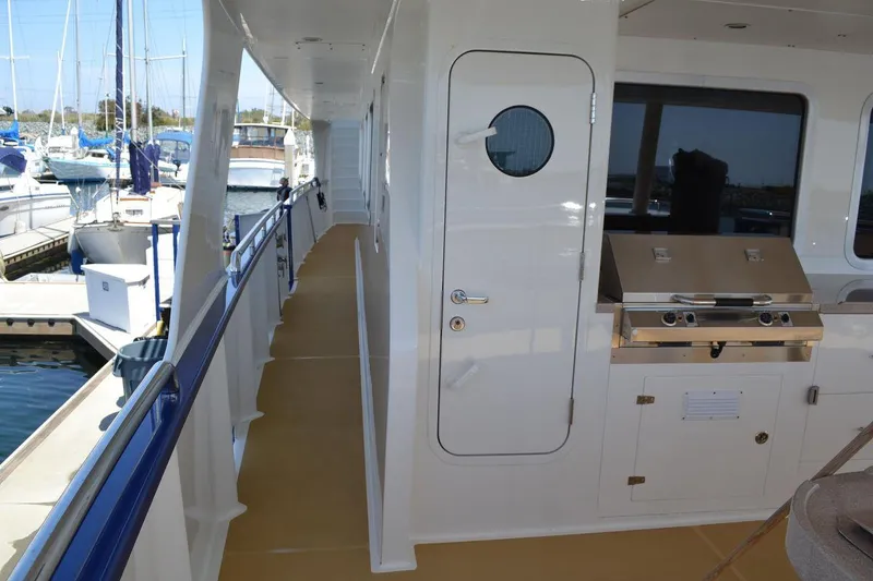 Slide: The Image of Side deck of 2016 Allseas Expedition 92 yacht with outdoor grill and marina view. - 13