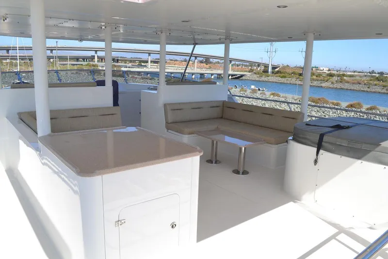 Slide: The Image of Allseas Expedition 92 (2016) yacht deck with seating area and table, docked by the water. - 16