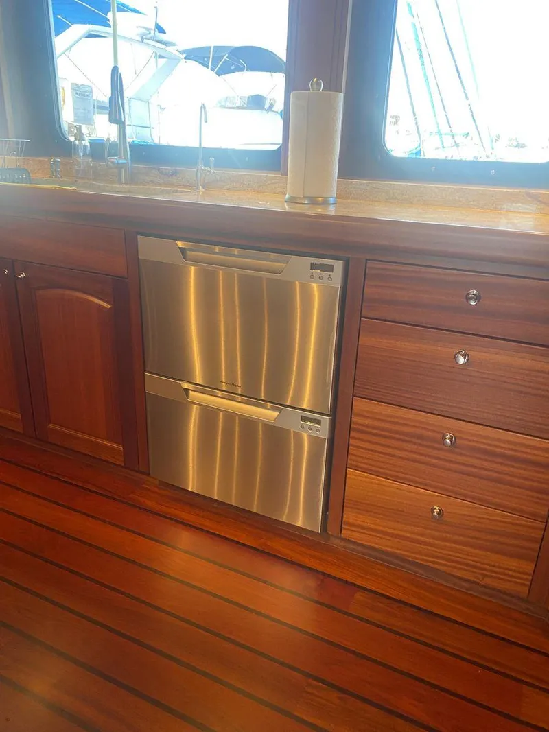 Slide: The Image of 2016 Allseas Expedition 92 yacht kitchen with stainless steel dishwasher and wooden cabinetry. - 25