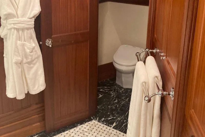 Slide: The Image of Luxurious bathroom in 2016 Allseas Expedition 92 yacht with wooden cabinets and marble flooring. - 37