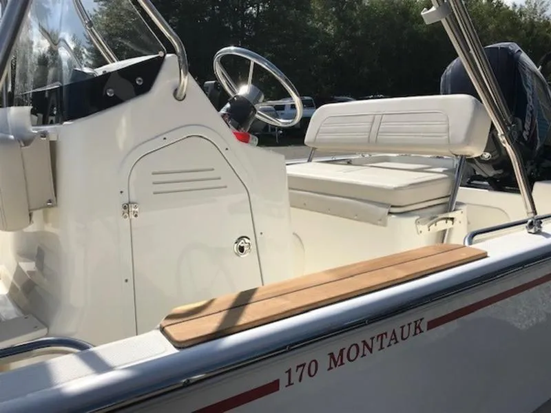 Slide: The Image of 2025 Boston Whaler 170 Montauk boat interior with steering wheel and seating. - 8