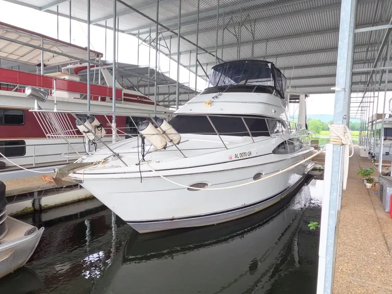 Slide: The Image of 2001 Carver 444 Cockpit Motor Yacht docked in a covered marina. - 1