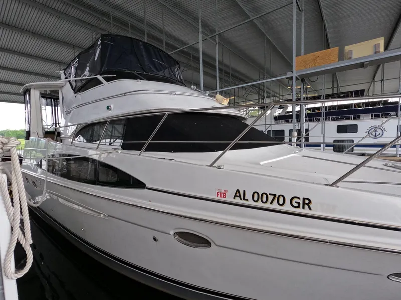 Slide: The Image of 2001 Carver 444 Cockpit Motor Yacht docked in a covered marina. - 10
