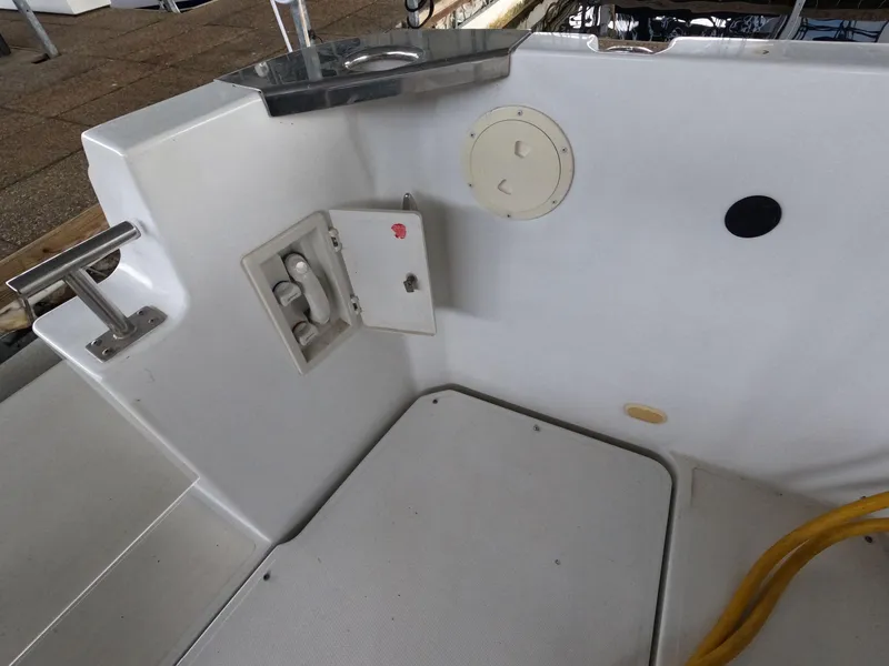 Slide: The Image of 2001 Carver 444 Cockpit Motor Yacht deck with utility access panel and storage. - 17