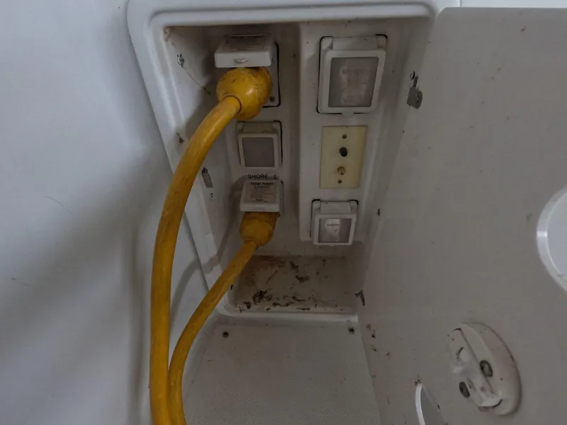 Slide: The Image of Electrical panel with yellow power cords on a 2001 Carver 444 Cockpit Motor Yacht. - 18