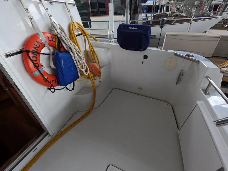 Slide: The Image of 2001 Carver 444 Cockpit Motor Yacht deck with life preserver and ropes. - 19