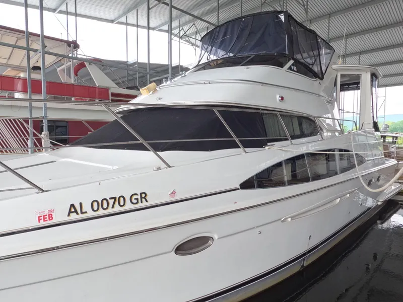 Slide: The Image of 2001 Carver 444 Cockpit Motor Yacht docked in a covered marina. - 2