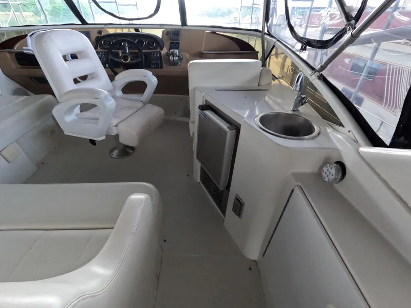 Slide: The Image of 2001 Carver 444 Cockpit Motor Yacht interior with helm, seating, and kitchenette. - 25