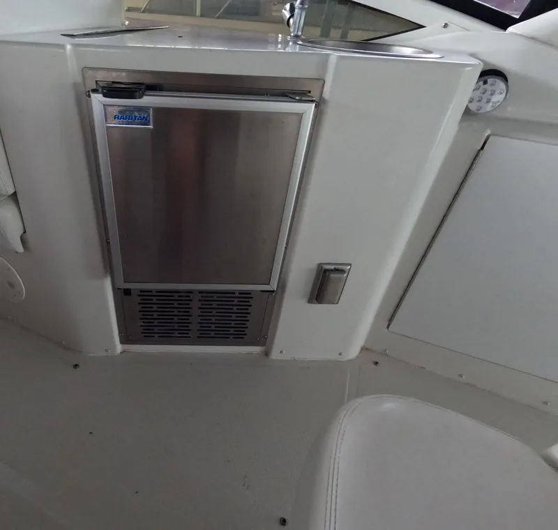 Slide: The Image of Interior of 2001 Carver 444 Cockpit Motor Yacht with built-in mini fridge and sink. - 28