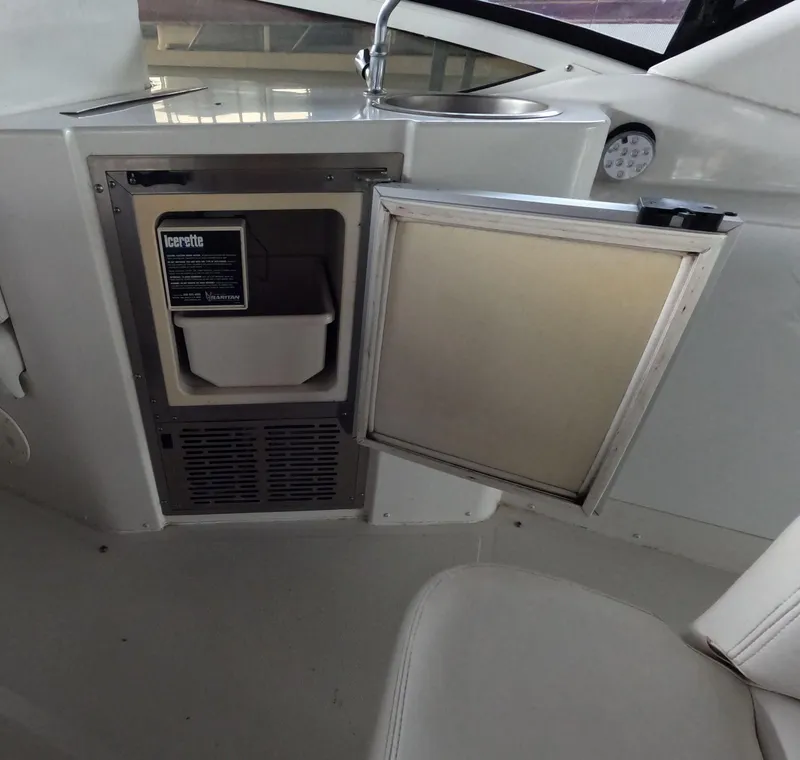 Slide: The Image of 2001 Carver 444 Cockpit Motor Yacht interior with open mini fridge and sink. - 29
