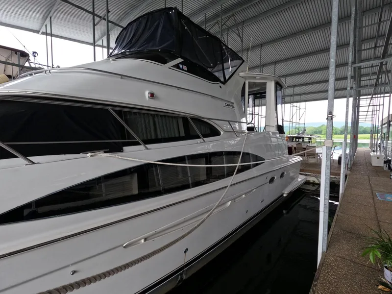 Slide: The Image of 2001 Carver 444 Cockpit Motor Yacht docked in a covered marina. - 3