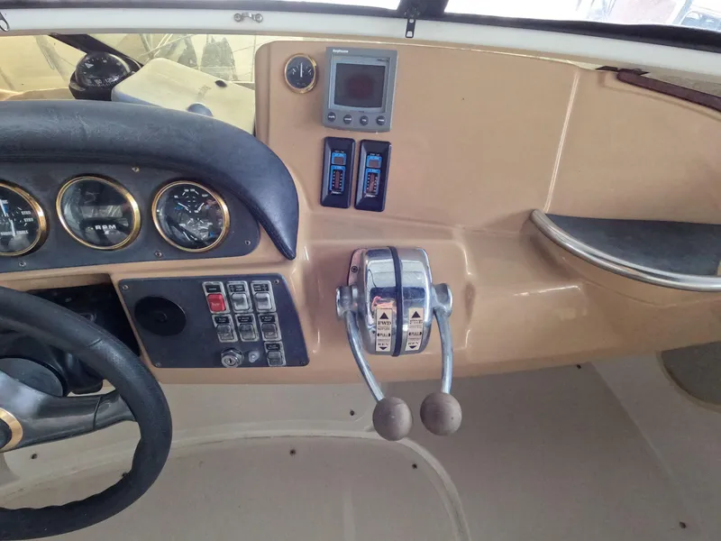 Slide: The Image of 2001 Carver 444 Cockpit Motor Yacht helm with gauges, controls, and navigation equipment. - 32