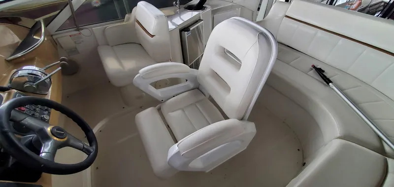 Slide: The Image of 2001 Carver 444 Cockpit Motor Yacht interior with white seating and steering wheel. - 33