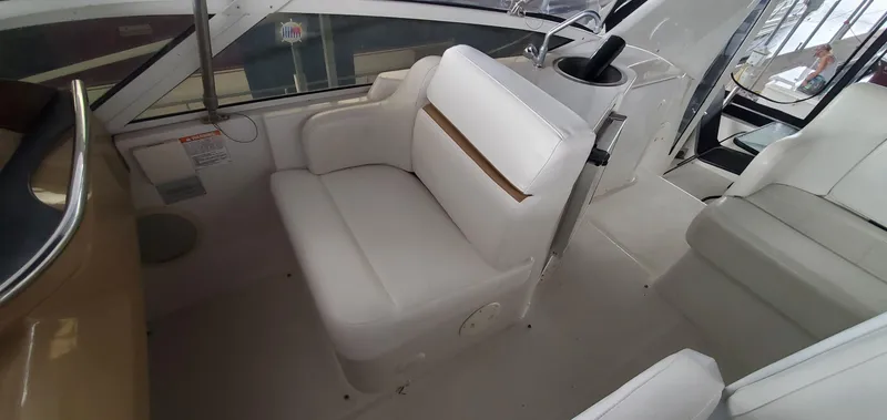 Slide: The Image of 2001 Carver 444 Cockpit Motor Yacht interior with white seating and helm station. - 34